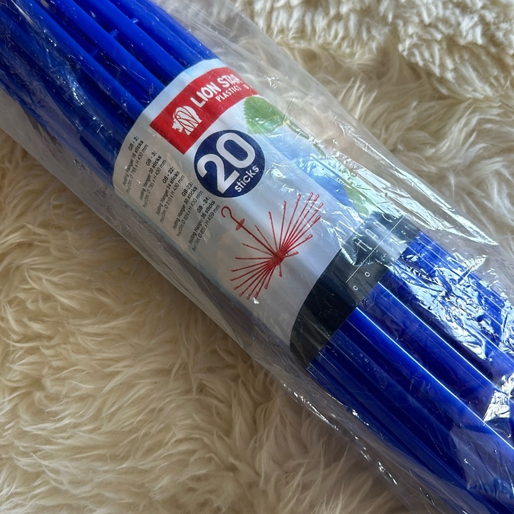 Bright blue hanging drying rack for clothes. Never opened. 17” long. Lightweight